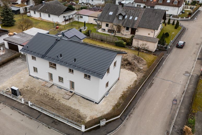 Luftaufnahme eines Hauses mit PV auf dem Dach