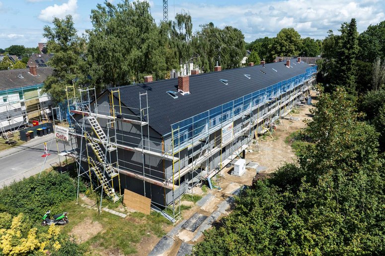 Mehrfamilienhaus mit Baugerüst während Sanierung, Draufsicht